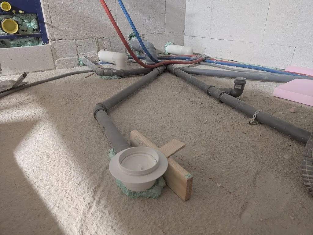 The plumbing in the bathroom floor, which will be covered by screed.