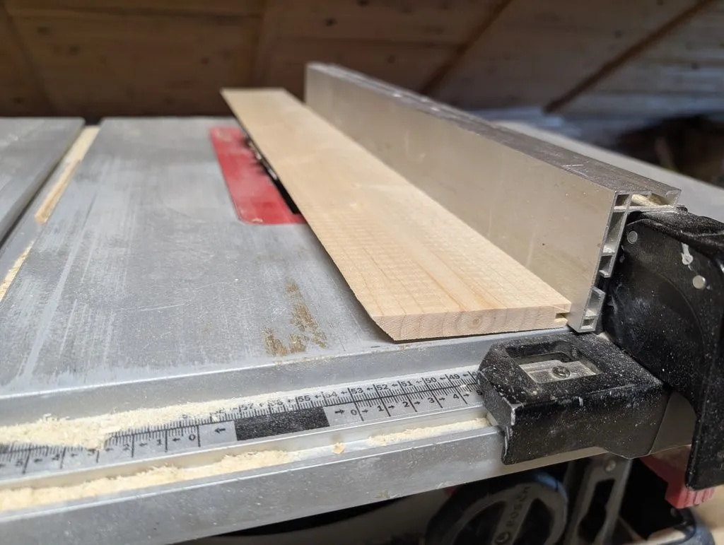 Shaping the threshold part 1: the end goal was a curved edge to match the profile of the arch of a human foot; I began by cutting a bevel on the table saw to get the rough shape.