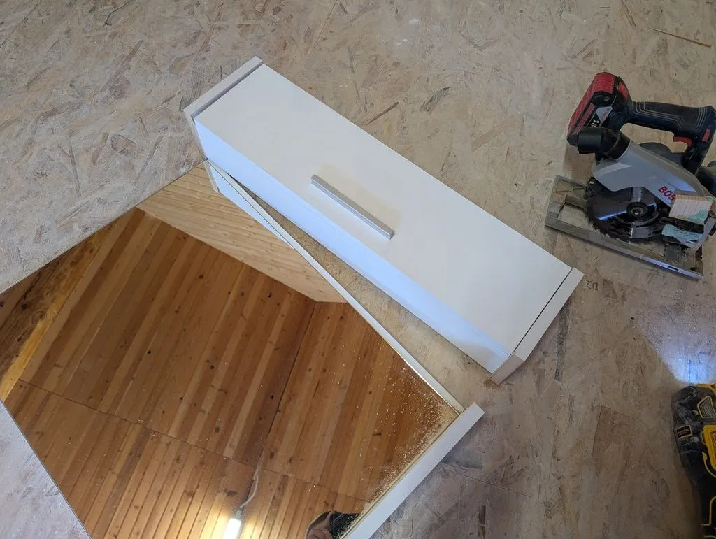 I separated the mirror from the shelf, because otherwise the assembly was too wide to install under the sloped bathroom ceiling.