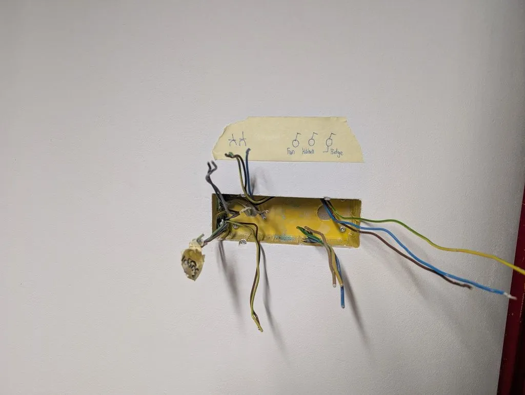 An electrical box in the Multipor wall to hold future outlets and switches. The box is fixed with gypsum-based plaster into a larger keyed hole cut into the Multipor wall. The Multipor itself is too brittle to reliably hold the box.