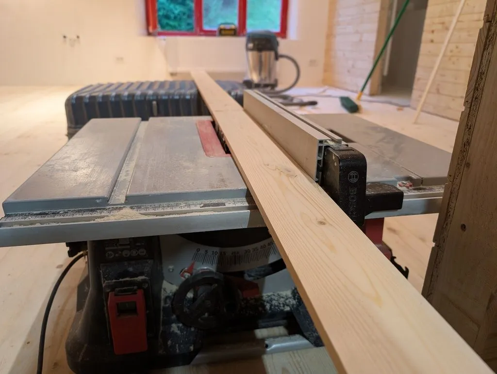Ripping the boards to width on the table saw. We used the same stock as for the tongue and groove wall finish.