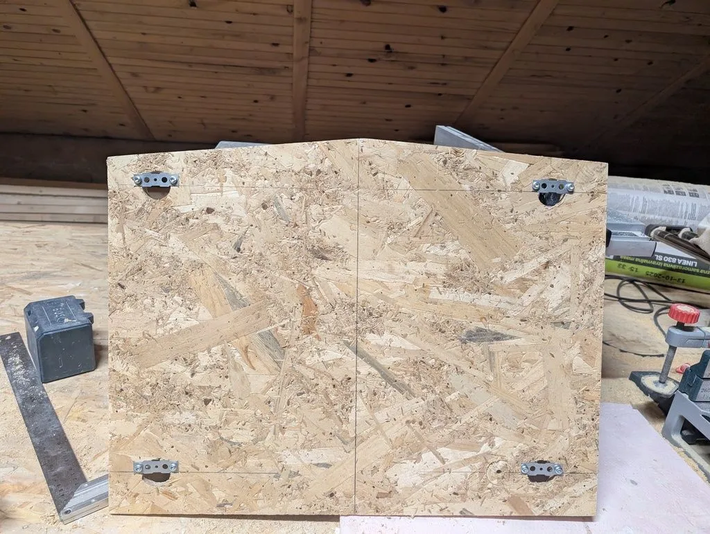 This OSB board will hold the mirror. The clips at the four corners will slip onto mounting brackets on the wall.