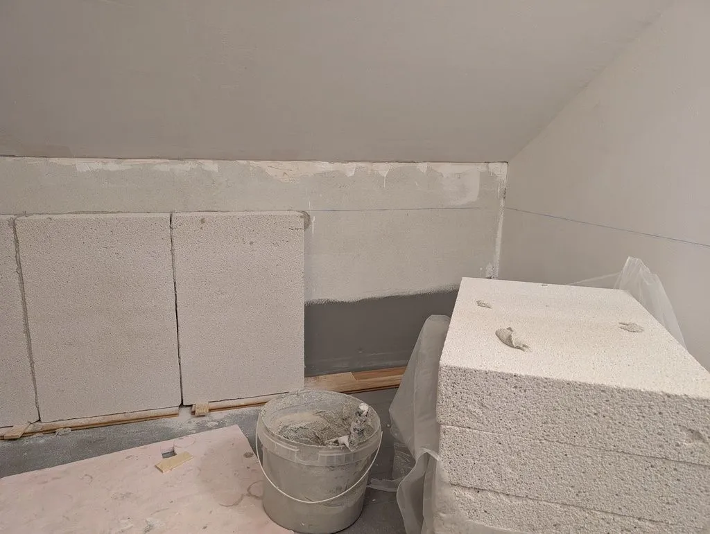 The bathtub enclosure is made of aerated concrete blocks. This is the first row of the flat area behind the bathtub.