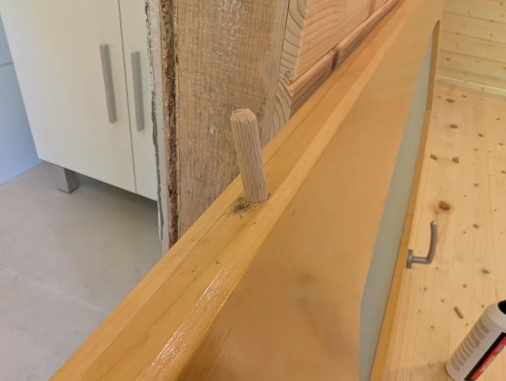 Filling the existing hole with a hardwood dowel, which is glued in place and left to sit until the glue dries.
