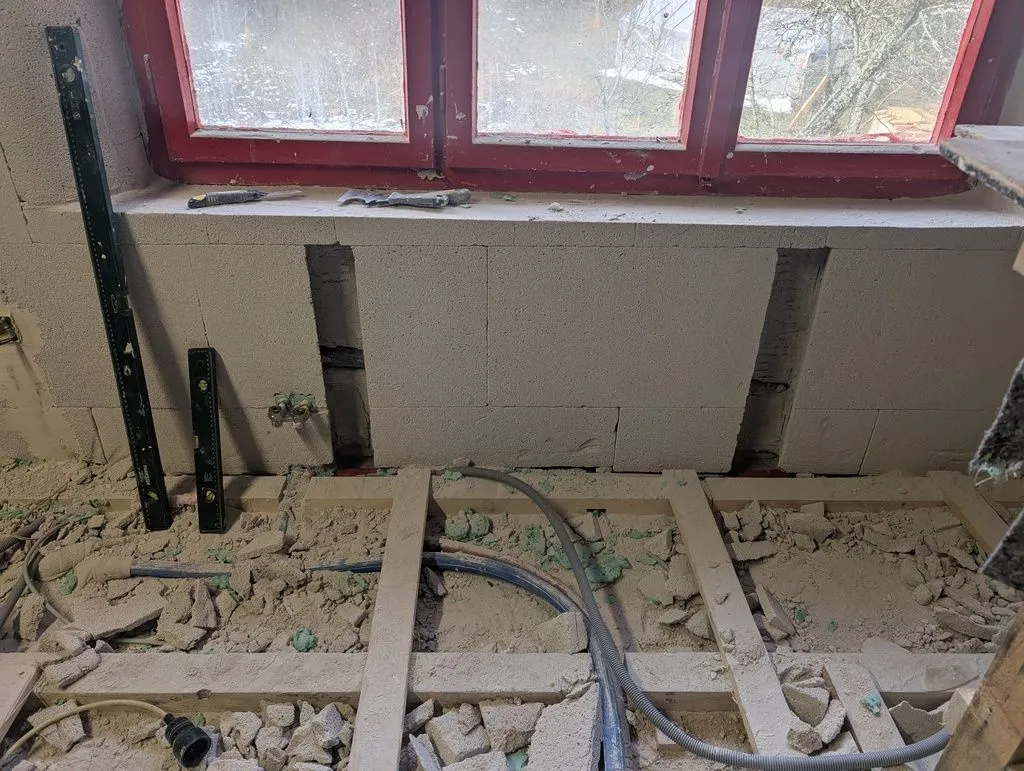 These two vertical channels cut into the Multipor wall will hold concrete columns supporting a radiator (Multipor is nonstructural and can't hold the radiator). The holes are keyed outward for a better mechanical bond between Multipor and concrete.