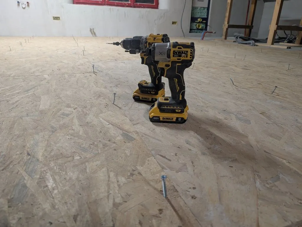 We fastened the subfloor to the substructure with screws. (Nails fired from a pneumatic nailgun are more conventional and faster, but I didn't own a framing nailgun at the time of this job. I did own an 18 gauge brad nailer, which will feature prominently when we get to finish work, but a brad nailer is not strong enough to attach the subfloor—you'd want a 15 or 16 gauge framing nailer.)