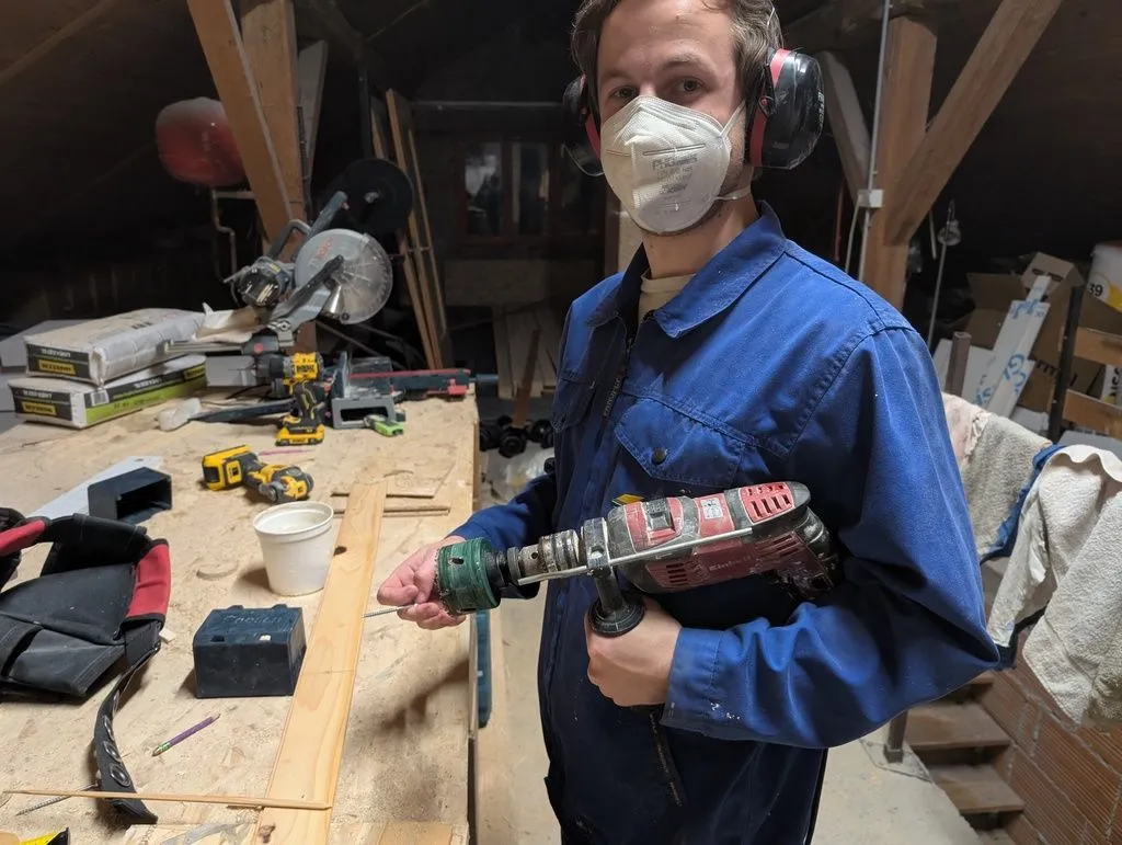 Martin with the drill and hole saw we used to drill the holes that would hold the recessed lights.