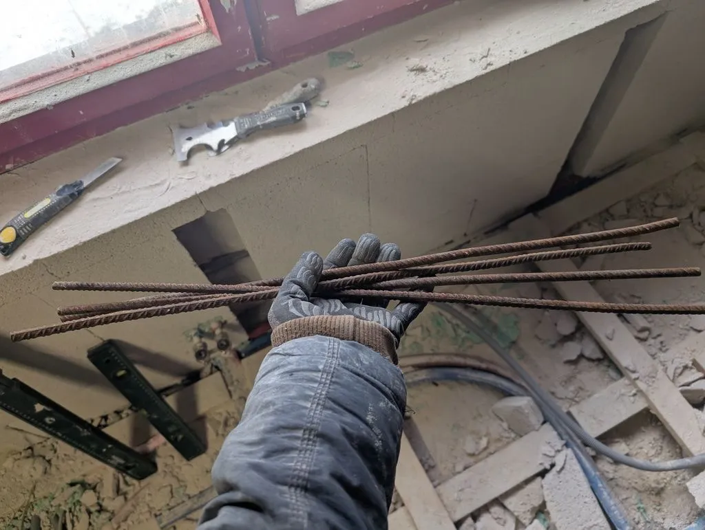 I added rebar stakes into the exterior wall and concrete floor slab as additional structural support, so as to (hopefully) lessen the Multipor's structural role.