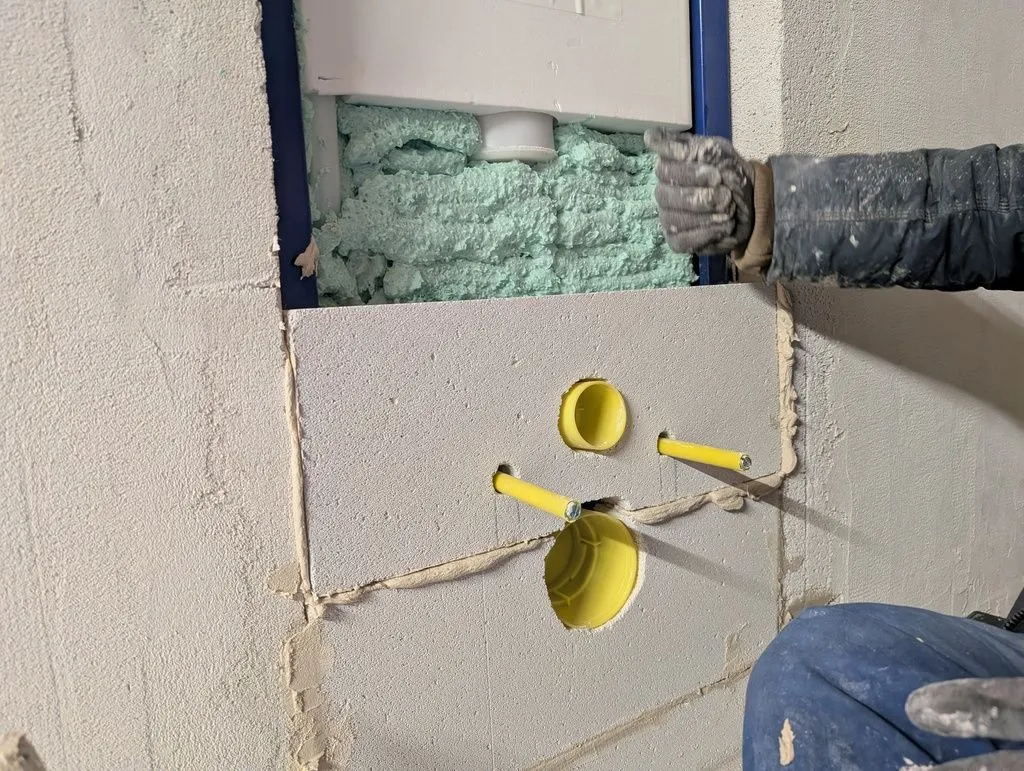 The aerated concrete blocks are attached with a mortar-like adhesive. Here I'm tapping down on the block to ensure a good mortar bond.