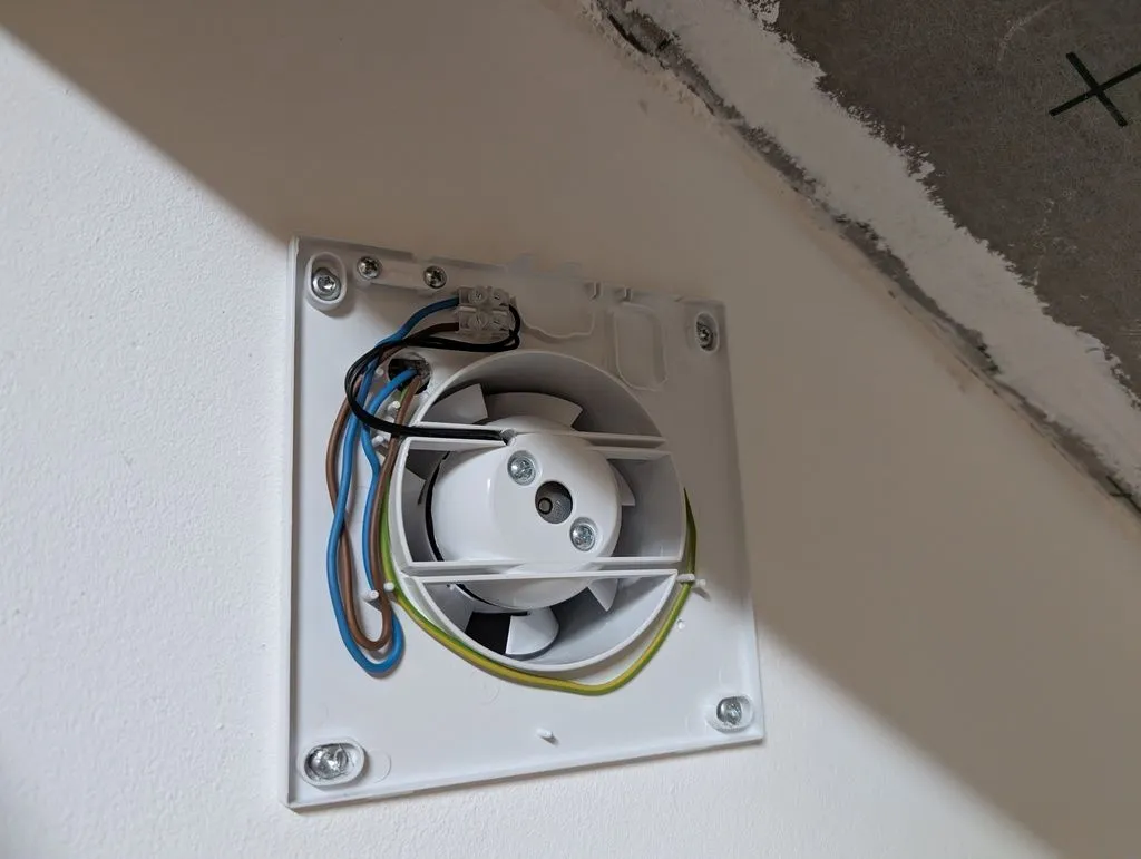 The wired-up bathroom fan.