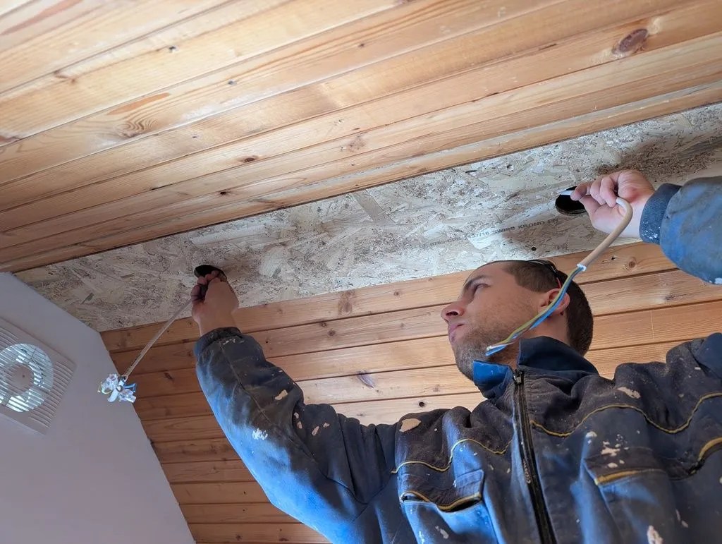 Running electrical cable from hole to hole to power the lights.