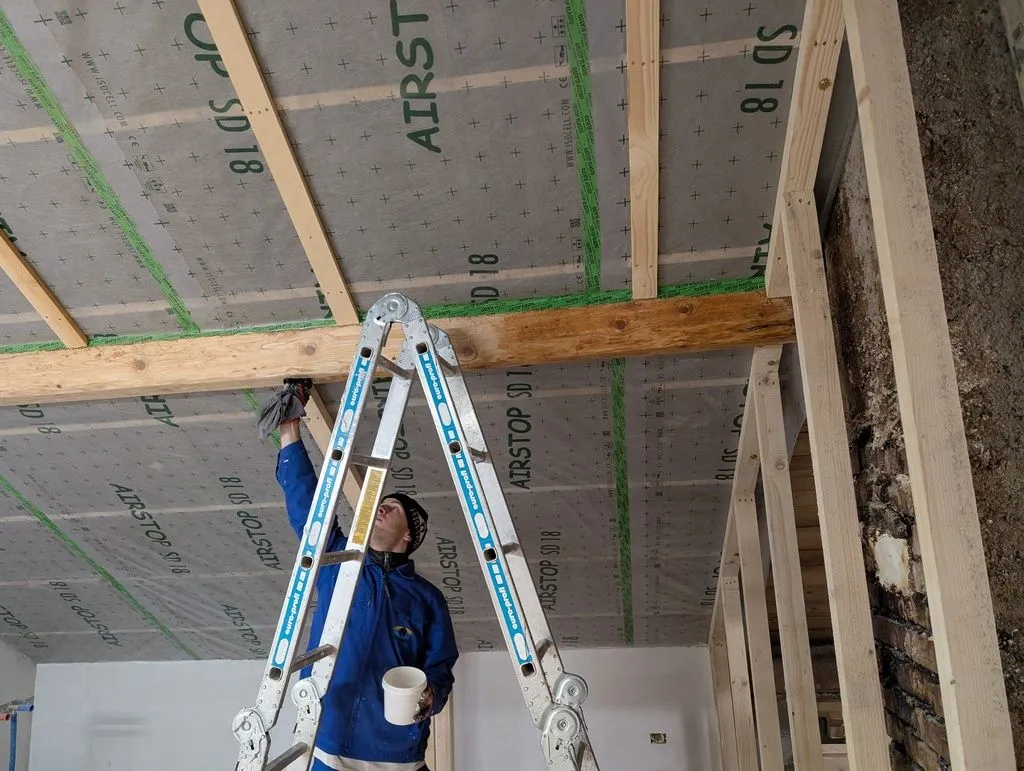 Here is Martin finishing the beams with linseed oil—he took care of almost all oil-based finishing on the job-both the beams and the later tongue and groove wall finish.