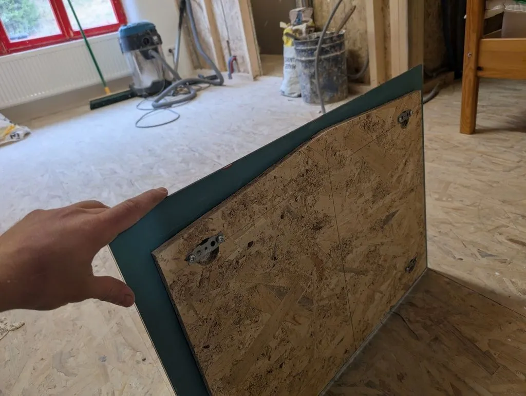 The mirror attached to the mounting board.
