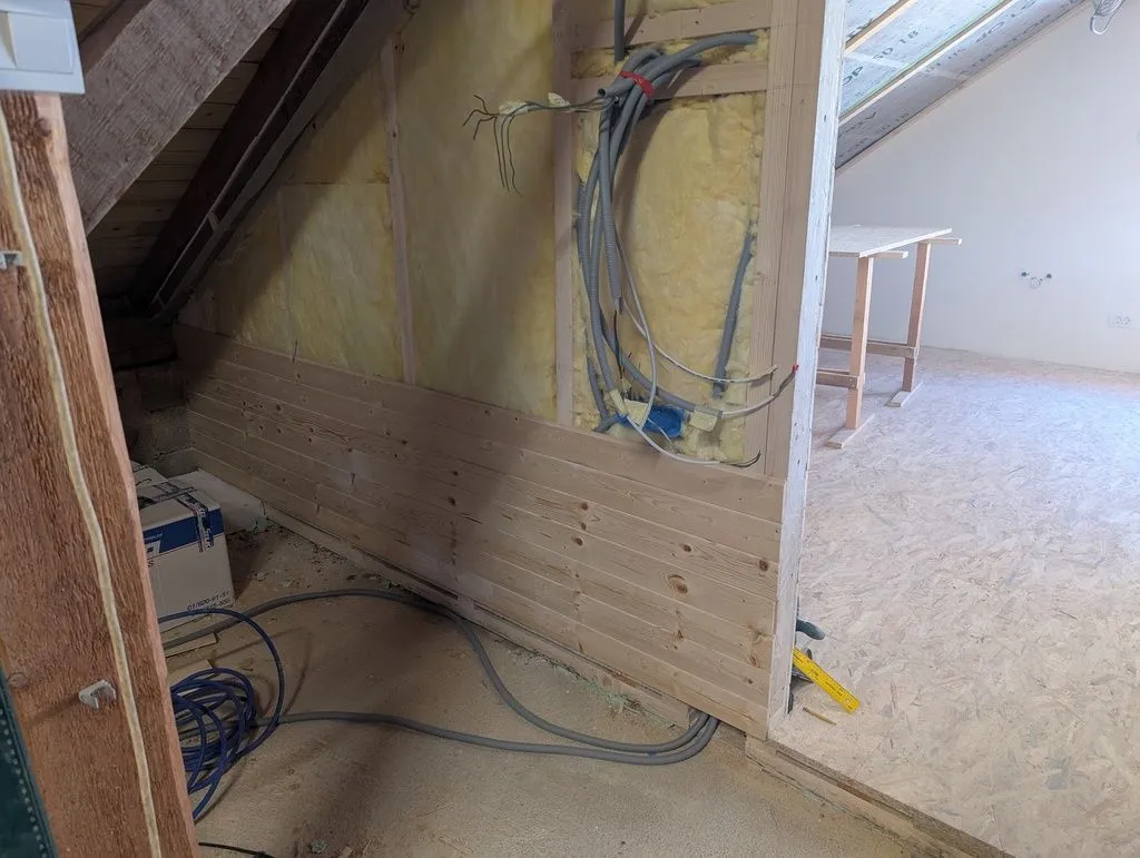 Installation of the tongue and groove wall finish in progress.