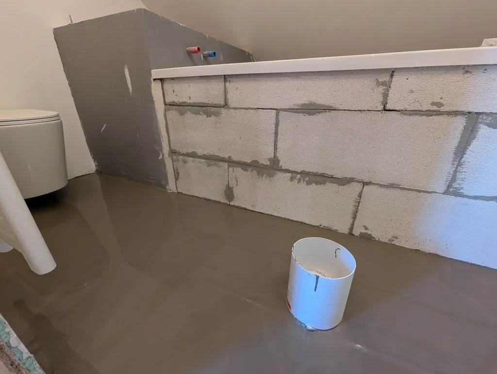 The poured self-leveling compound, which produces a smooth, level, planar surface.