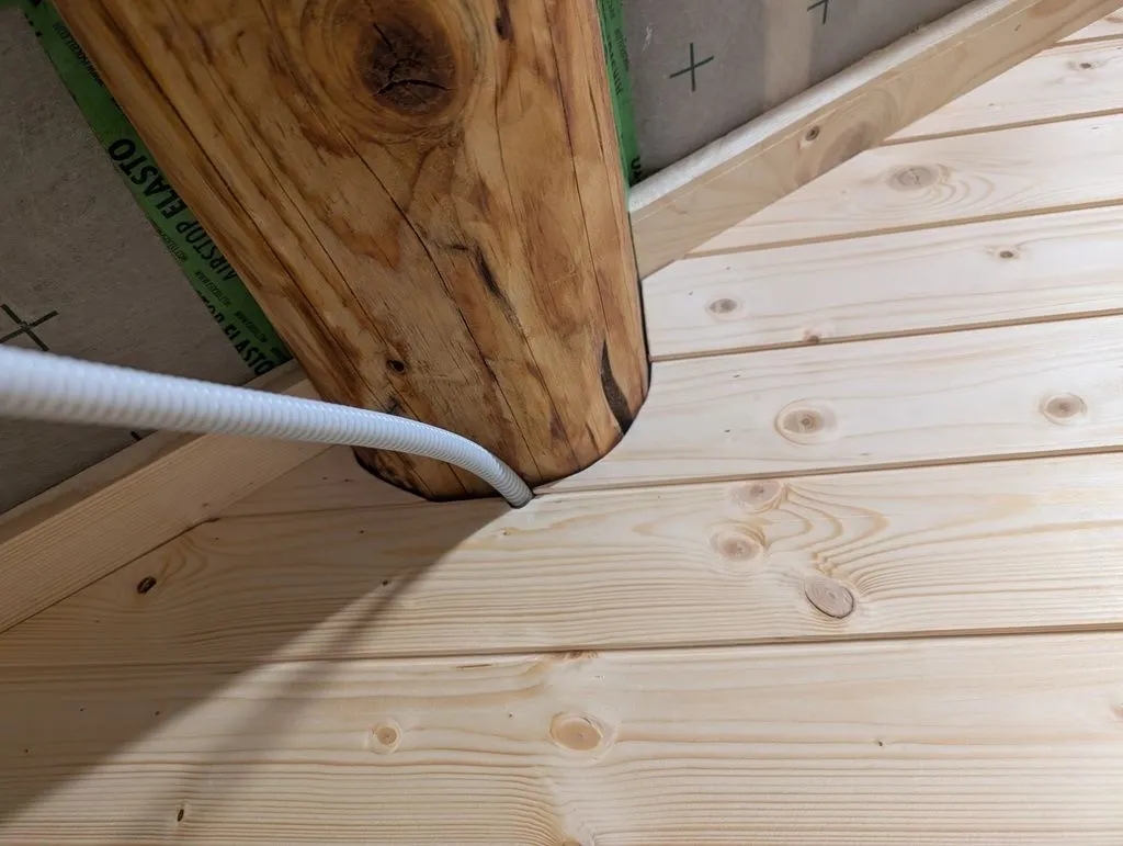 It took some scribing and jigsaw heroics to match the tongue and groove boards to the contours of the main structural beams.