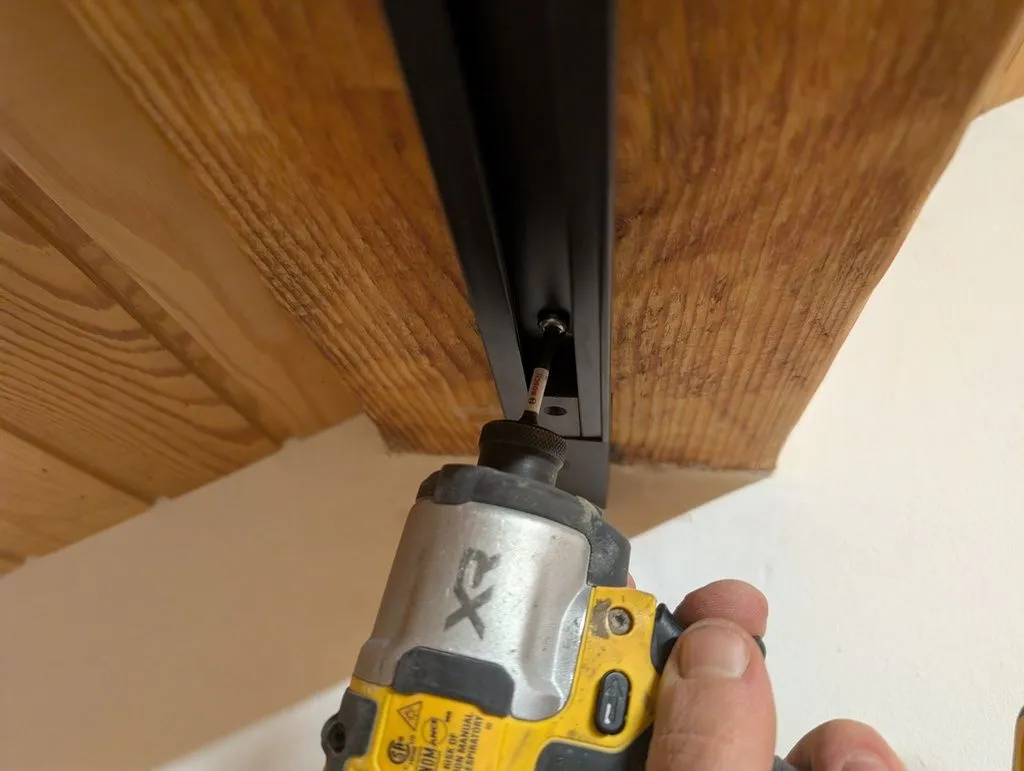 Attaching the track to the beam.