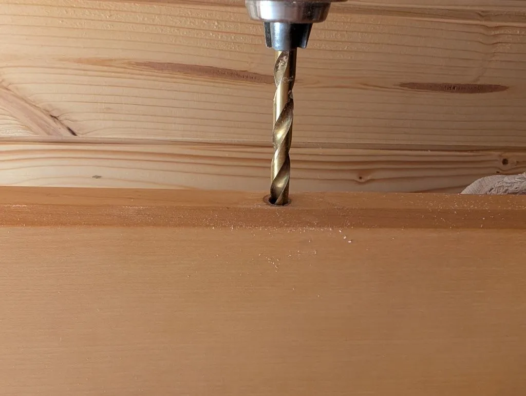 Drilling the correct diameter pilot hole for the new hinges.