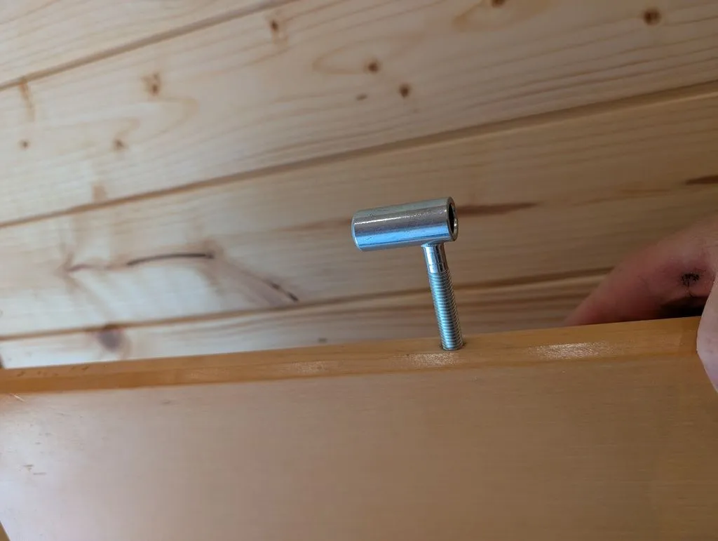 The new hinge is screwed into the new pilot hole and fits over a matching pin in the door jamb.