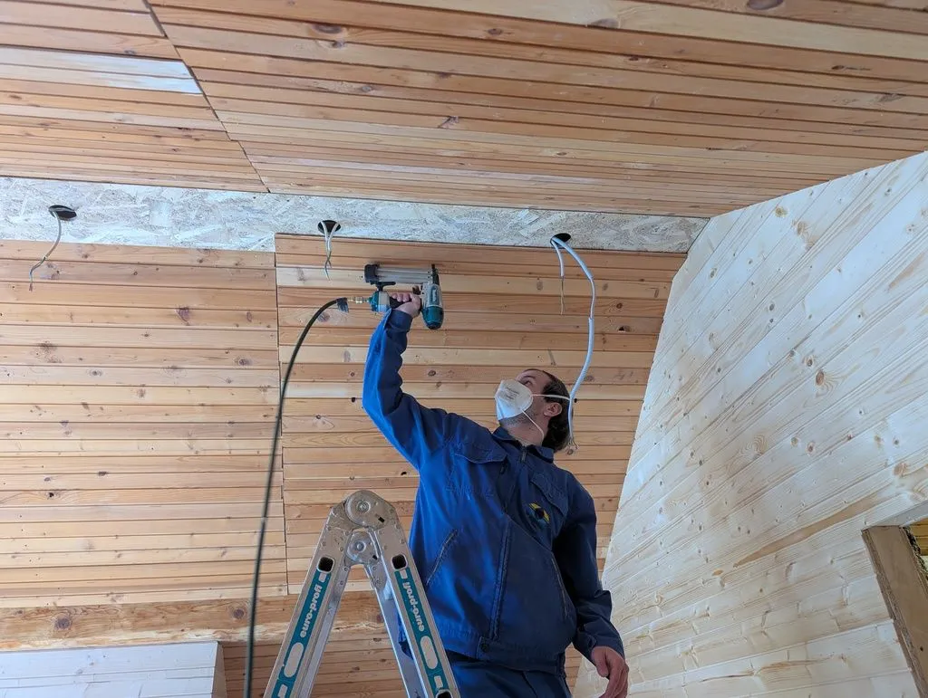 Martin attaching tongue and groove finish ceiling to the OSB soffit.
