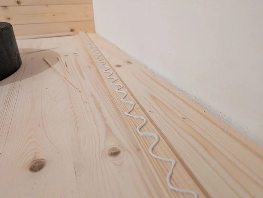 We attached the boards with construction adhesive in the masonry portions of the wall, which would not accept fasteners.