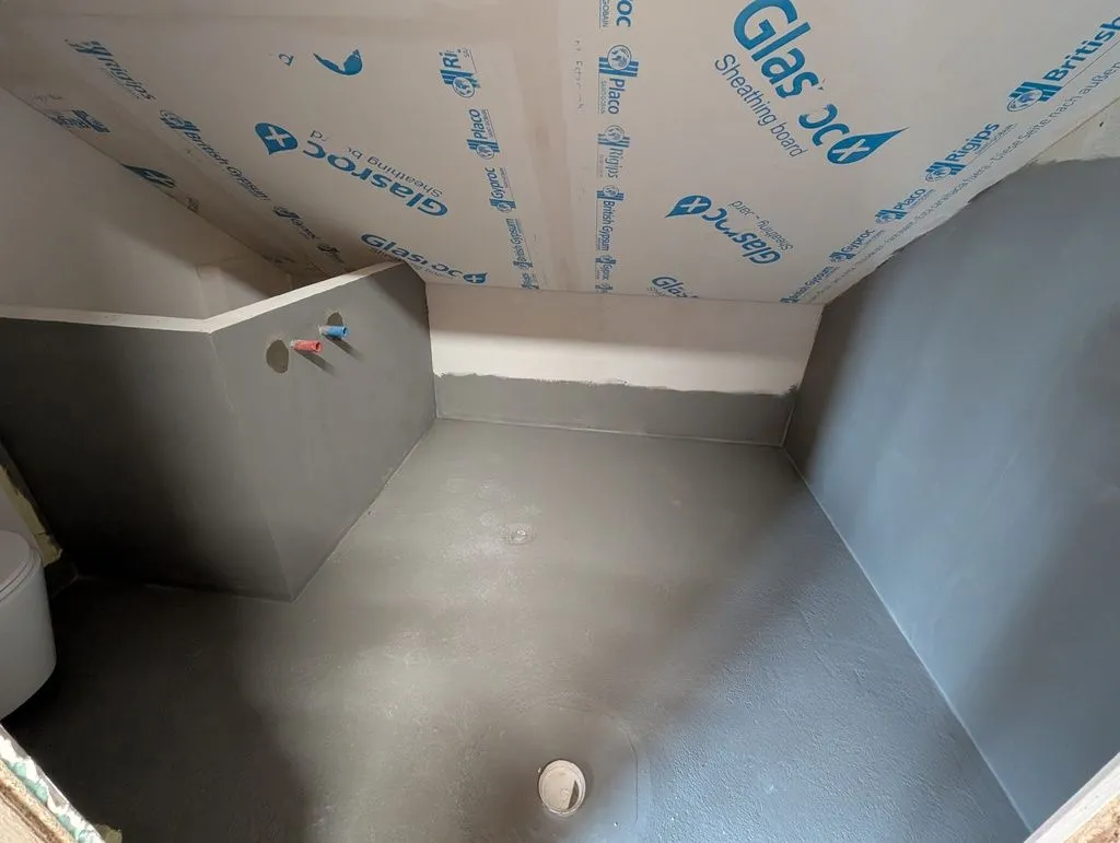 The waterproofed bathroom. We covered the entire floor and the walls around the wet areas by the bathroom and sink.