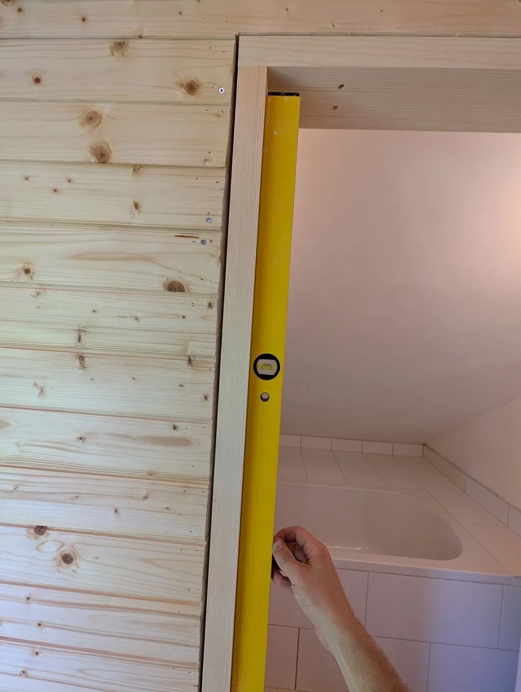 Ensuring the side jambs are plumb before attaching them.