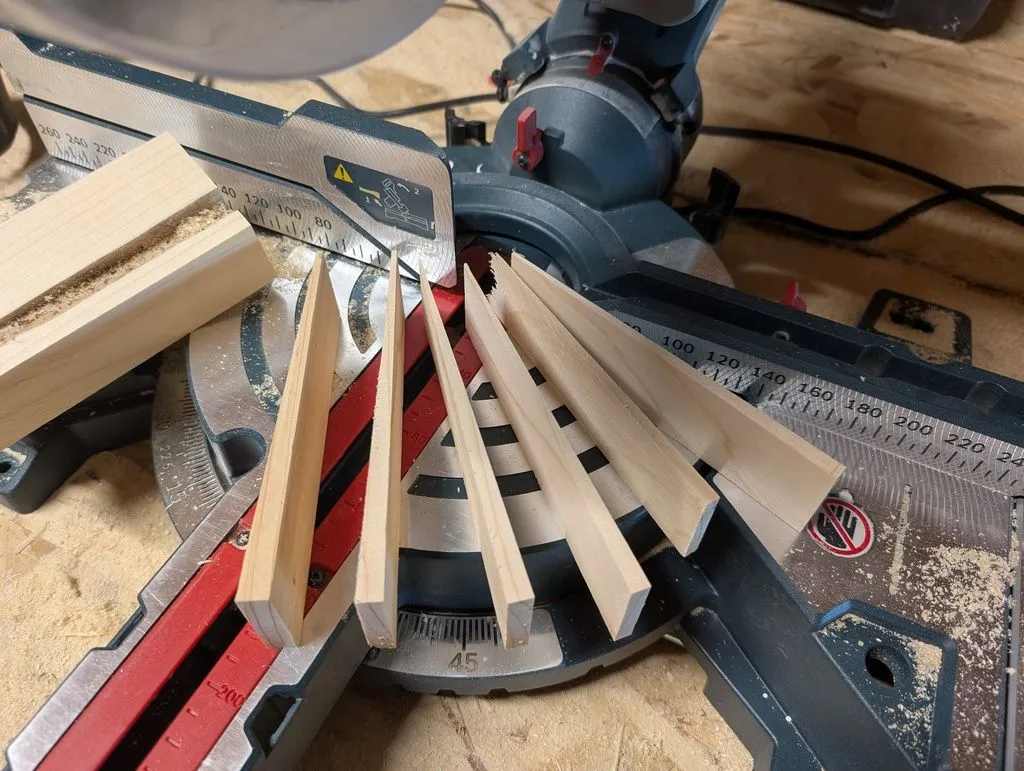Cutting shims on the miter saw. I would use these shims to plumb and level the jambs.