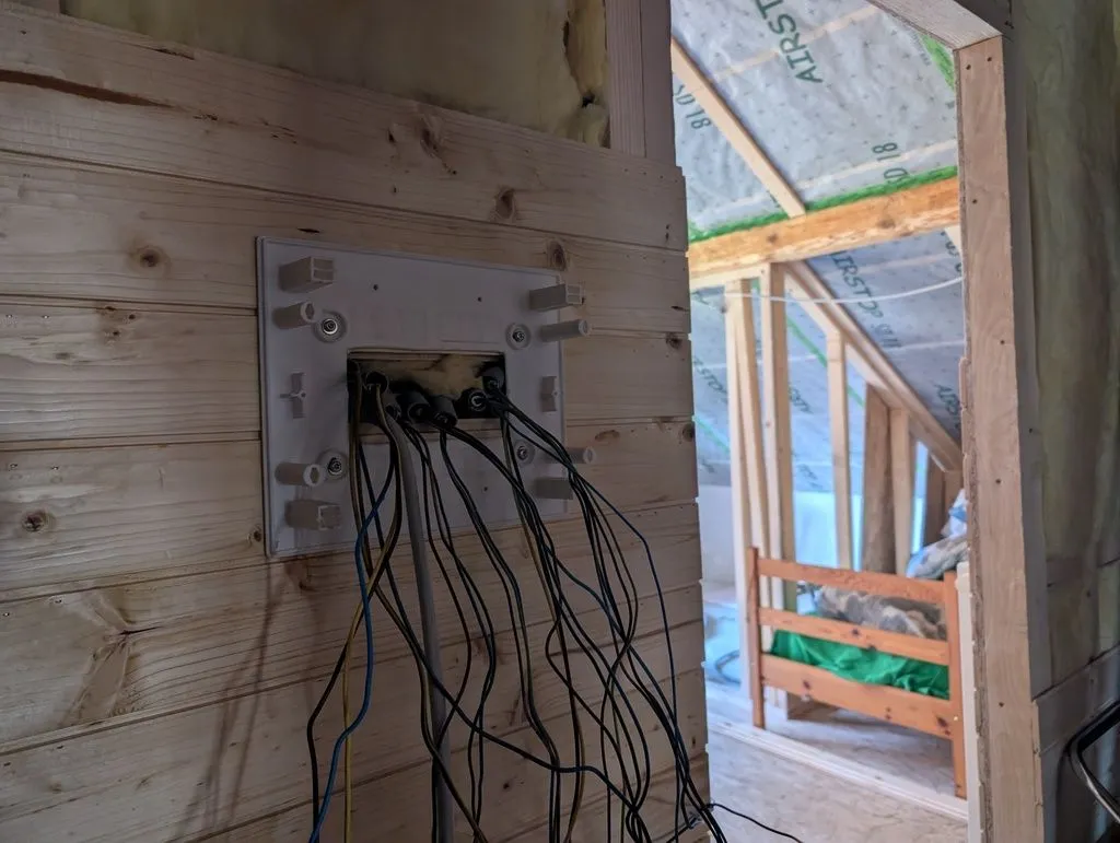 Conduit trimmed to length and outer cable sheathing stripped, exposing the individual conductors.