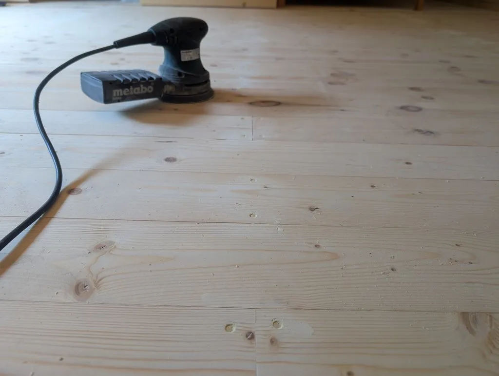 Sanding away filler that made it out of the screw holes between applications.