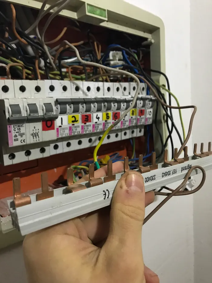 The removed three-phase rail originally used to distribute power across the breakers of my one-phase panel.