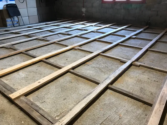 The top layer of the sleeper grid, made of 1 inch thick spruce. OSB panels go on top.