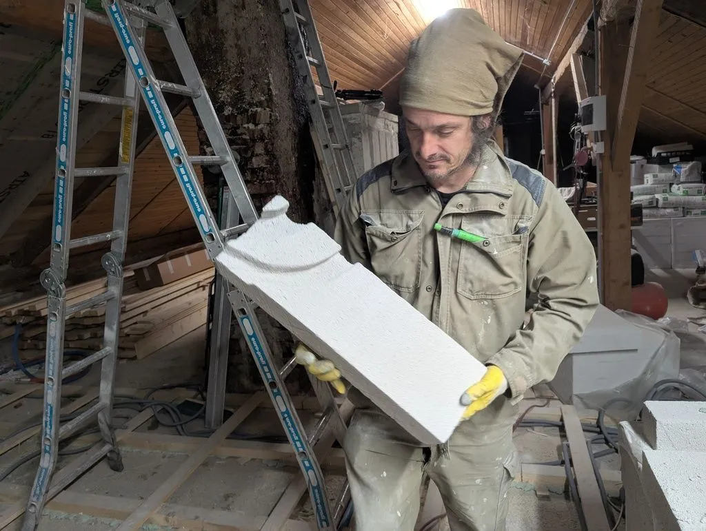 My cousin Anže, who was a crucial help during a few critical phases of the project, including the Multipor installation along the west wall. Here he is holding a block with grooves carved in to fit around water supply lines.