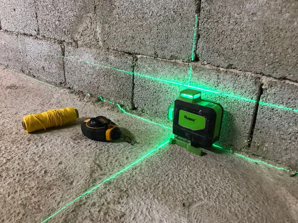 We used a laser level and chalkline to lay out the grid's position on the floor slab.