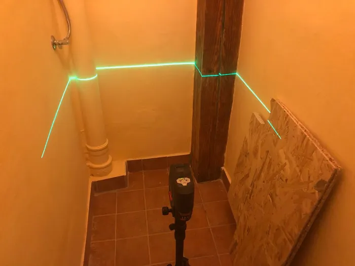 Using a laser level to Laying out level lines for the ledgers that will support the desk