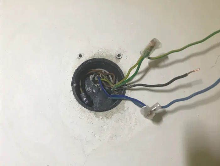 The fire-retardant high-impact polystyrene junction box replacing the original makeshift wooden box.