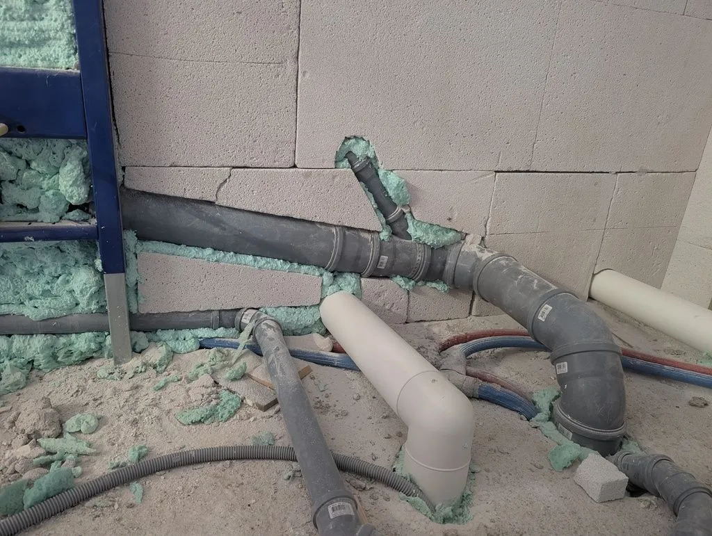 We carved out the Multipor blocks to fit around the plumbing installation—luckily the material is quite soft and easily worked.