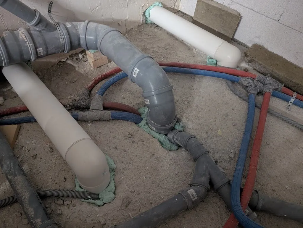 We ran the main drain and supply lines from the downstairs bathroom through the floor slab.